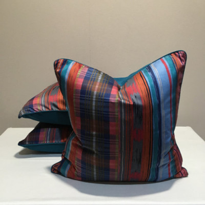 Vibrant striped and checked pattern scatter cushion on silk base with turquoise contrast  piping and back